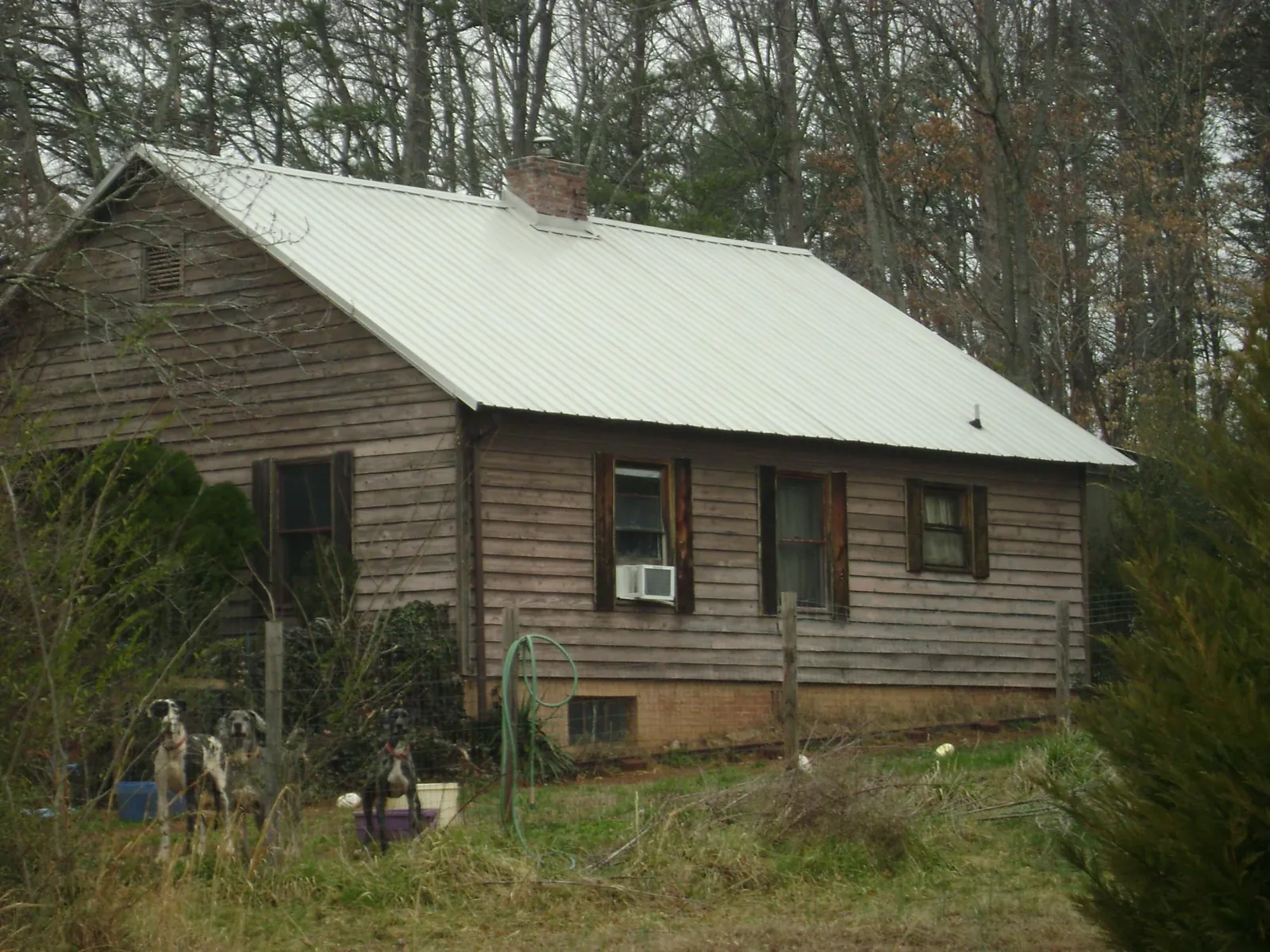 White metal roof on an old wood sided farmhouse, from a Metal Roof Installation job in Imler